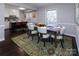 Elegant dining room with a wood table, six chairs, and a stylish rug at 6742 Constitution Ln, Charlotte, NC 28210