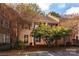 Tan brick townhouse with front porch and landscaping at 6742 Constitution Ln, Charlotte, NC 28210