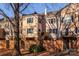 Back exterior view of a townhome with a deck and brick wall at 6742 Constitution Ln, Charlotte, NC 28210