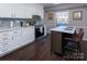 Modern kitchen with white cabinets, stainless steel appliances, and a large island at 6742 Constitution Ln, Charlotte, NC 28210