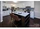 Modern kitchen with white cabinets, stainless steel appliances, and a large island at 6742 Constitution Ln, Charlotte, NC 28210