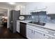 Modern kitchen with white cabinets, stainless steel appliances, and a large island at 6742 Constitution Ln, Charlotte, NC 28210