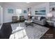 Bright living room with hardwood floors, comfy seating, and large windows at 6742 Constitution Ln, Charlotte, NC 28210