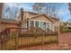 House with a sunroom and wooden deck, fenced backyard at 6800 April Ln, Charlotte, NC 28215