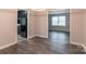 Dining area with dark laminate floors and kitchen access at 6800 April Ln, Charlotte, NC 28215