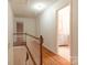 Upstairs hallway with hardwood floors and access to bedrooms at 6800 April Ln, Charlotte, NC 28215