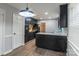 Modern kitchen with dark cabinetry, stainless steel appliances, and a breakfast bar at 6800 April Ln, Charlotte, NC 28215