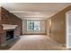 Living room with brick fireplace and built-in shelving at 6800 April Ln, Charlotte, NC 28215