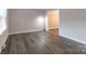Living room with gray walls and dark laminate floors at 6800 April Ln, Charlotte, NC 28215