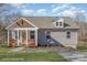 Newly built craftsman style home with gray siding, a covered porch, and a landscaped yard at 828 Cabaniss Dr, Shelby, NC 28150
