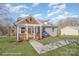 Charming craftsman style home with gray siding, a covered porch, and a landscaped yard at 828 Cabaniss Dr, Shelby, NC 28150