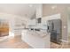 Modern kitchen with white cabinets, granite countertops, and stainless steel appliances at 828 Cabaniss Dr, Shelby, NC 28150