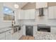 Modern kitchen with white cabinets, granite counters, and stainless steel appliances at 828 Cabaniss Dr, Shelby, NC 28150