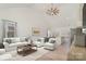Open living room featuring vaulted ceilings, hardwood floors, and a view into the kitchen at 828 Cabaniss Dr, Shelby, NC 28150