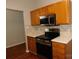 Kitchen with wood cabinets, stainless steel appliances, and white countertops at 8540 Filbert Ln, Charlotte, NC 28215