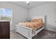 Cozy bedroom with a white bed frame and patterned bedding at 8932 Pennegrove Cir, Charlotte, NC 28214