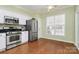 Eat-in kitchen featuring stainless steel appliances and hardwood floors at 9021 Gander Dr, Charlotte, NC 28277