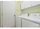 Laundry room with washer, dryer, and upper cabinets at 9021 Gander Dr, Charlotte, NC 28277