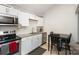 Modern kitchen with white cabinets and granite countertops at 92 Saint Charles Ne Ave, Concord, NC 28025