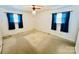 Bright bedroom featuring carpet, two windows, and ceiling fan at 947 Ravendale Dr, Charlotte, NC 28216