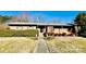 Ranch home with brick facade, landscaping, and walkway at 947 Ravendale Dr, Charlotte, NC 28216