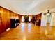 Living room with hardwood floors, wood paneling, and fireplace at 947 Ravendale Dr, Charlotte, NC 28216