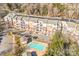 Aerial view of a multi-unit residential building with a swimming pool at 1000 E Woodlawn Rd # 105, Charlotte, NC 28209