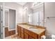 Bathroom with granite double vanity and a view to bedroom at 1000 E Woodlawn Rd # 105, Charlotte, NC 28209