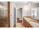 Double vanity bathroom with granite countertops and large shower at 1000 E Woodlawn Rd # 105, Charlotte, NC 28209