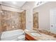Clean bathroom with granite vanity and bathtub at 1000 E Woodlawn Rd # 105, Charlotte, NC 28209
