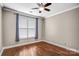 Spacious bedroom featuring hardwood floors and a ceiling fan at 1000 E Woodlawn Rd # 105, Charlotte, NC 28209