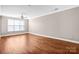 Bright bedroom featuring hardwood floors and a ceiling fan at 1000 E Woodlawn Rd # 105, Charlotte, NC 28209