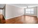 Spacious living room with hardwood floors and large window at 1000 E Woodlawn Rd # 105, Charlotte, NC 28209