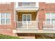 Private patio with brick exterior and white railings at 1000 E Woodlawn Rd # 105, Charlotte, NC 28209