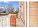 Side patio with brick pillars and a white railing at 1000 E Woodlawn Rd # 105, Charlotte, NC 28209