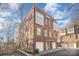 Brick three-story townhome with two-car garage and front yard at 106 N Laurel Ave # 120, Charlotte, NC 28207