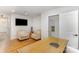 Home office with two armchairs, a desk and a large TV at 106 N Laurel Ave # 120, Charlotte, NC 28207