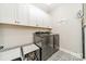 Laundry room with washer, dryer, and ample cabinet space at 1140 Overlake Dr, Belmont, NC 28012