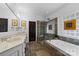 Spa-like bathroom with double vanity, soaking tub, and glass shower at 12466 Preservation Pointe Dr, Charlotte, NC 28216