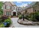 Brick home with a fountain and walkway leading to the entrance at 12466 Preservation Pointe Dr, Charlotte, NC 28216