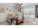 Cozy bedroom with a bed, wooden bench, and window seat at 140 Colonial Reserve Ave, Troutman, NC 28166