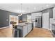 Island kitchen with granite countertops, stainless steel appliances, and access to backyard at 140 Colonial Reserve Ave, Troutman, NC 28166