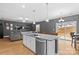 Open concept kitchen with island, granite countertops, and stainless steel appliances at 140 Colonial Reserve Ave, Troutman, NC 28166