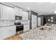 Modern kitchen features white cabinets, granite countertops, and stainless steel appliances at 140 Colonial Reserve Ave, Troutman, NC 28166