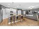 Modern kitchen with white cabinets, granite countertops, and island at 140 Colonial Reserve Ave, Troutman, NC 28166