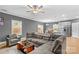 Open living room with L-shaped sectional sofa and kitchen view at 140 Colonial Reserve Ave, Troutman, NC 28166