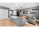 Living room with sectional sofa, wood floors, and gray walls at 140 Colonial Reserve Ave, Troutman, NC 28166