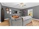 Living room with sectional sofa, gray walls, and a large TV at 140 Colonial Reserve Ave, Troutman, NC 28166