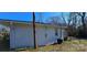 Side view of a white cottage with AC unit and deck at 153 Saluda St, Chester, SC 29706