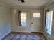 Living room with two windows, a door, and an area rug at 153 Saluda St, Chester, SC 29706